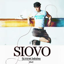 Ein Mann lehnt lässig an einer Wand, trägt eine Mütze und ein T-Shirt. Darunter steht 'SIOVO für immer:babyboy (tour)'., © links im Bild Ein Mann lehnt lässig an einer Wand, trägt eine Mütze und ein T-Shirt. Darunter steht 'SIOVO für immer:babyboy (tour)'., © links im Bild