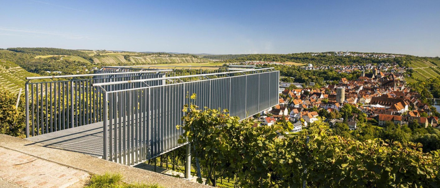 A modern observation deck offers a sweeping view of the town of Besigheim and the surrounding vineyards under a clear, blue sky., © SMG Stuttgart Marketing GmbH - Sarah Schmid A modern observation deck offers a sweeping view of the town of Besigheim and the surrounding vineyards under a clear, blue sky., © SMG Stuttgart Marketing GmbH - Sarah Schmid