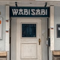 Exterior view of the Wabisabi Bar, showing the entrance door, signs, and the house number 43. The bar offers drinks, music, and Cup Noodles., © SMG Stuttgart Marketing GmbH - Thabea Zauder Exterior view of the Wabisabi Bar, showing the entrance door, signs, and the house number 43. The bar offers drinks, music, and Cup Noodles., © SMG Stuttgart Marketing GmbH - Thabea Zauder