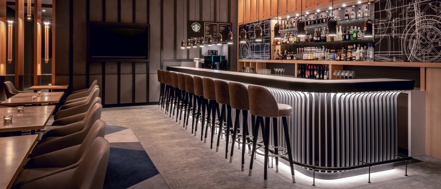 Elegant bar with long counters, bar stools and illuminated shelves full of bottles. Modern furnishings with warm lighting and stylish details., © Stuttgart Marriott Hotel Sindelfingen Elegant bar with long counters, bar stools and illuminated shelves full of bottles. Modern furnishings with warm lighting and stylish details., © Stuttgart Marriott Hotel Sindelfingen