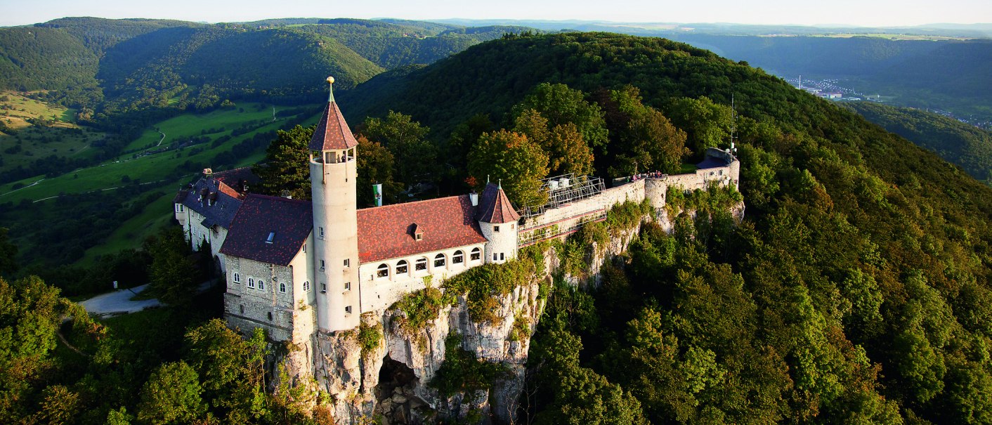 Teck Castle stands majestically atop a wooded hill, surrounded by green valleys and forests in the distance., © © Stuttgart-Marketing GmbH Teck Castle stands majestically atop a wooded hill, surrounded by green valleys and forests in the distance., © © Stuttgart-Marketing GmbH