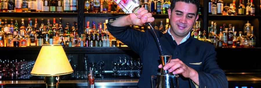 A bartender pours gin into a jigger. Numerous bottles can be seen on a shelf in the background., &copy; &copy; TMBW, Gregor Lengler