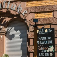 Eingang zu 'Onkel Otto', einem XXL-Schnitzelparadies, mit dekorativem Schild und Tafel mit Spruch &uuml;ber Zitronen., &copy; SMG, Sarah Schmid