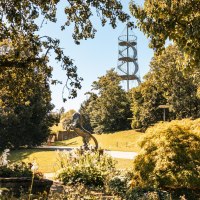 A green park with trees, a horse sculpture and a spiral-shaped observation tower in the background., &copy; SMG Stuttgart Marketing GmbH - Sarah Schmid