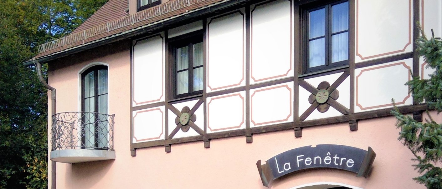 Half-timbered house with 'La Fen&ecirc;tre' sign, small balcony, well-tended garden and flowering plants in front of the door., &copy; relexa Waldhotel Schatten