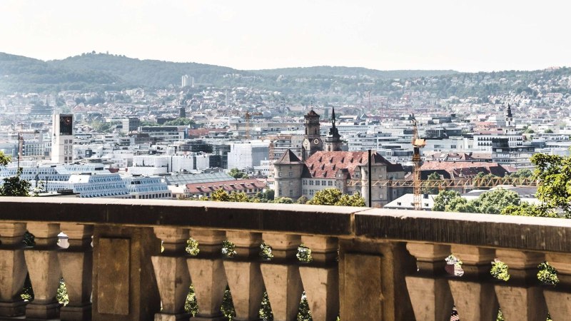 View of Stuttgart from Eugensplatz, with historic buildings and green hills in the background. A railing in the foreground., &copy; Stuttgart-Marketing GmbH Romeo Felsenreich, sommertage.com