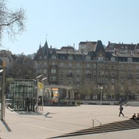 Marienplatz in Stuttgart with streetcar, modern and historic buildings. People sitting on steps, trees without leaves, sunny day., © Stuttgart-Marketing GmbH Marienplatz in Stuttgart with streetcar, modern and historic buildings. People sitting on steps, trees without leaves, sunny day., © Stuttgart-Marketing GmbH