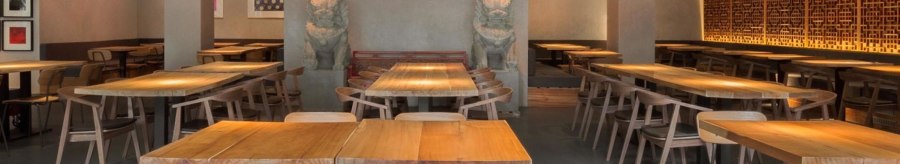 Modern restaurant with wooden tables, chairs and Asian decorations. Subtle lighting and artistic wall design create an inviting atmosphere., © Breitengrad17, Stuttgart