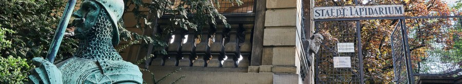 Entrance to the Municipal Lapidarium with a green knight statue in the foreground and a gate in the background., &copy; &copy; St&auml;dtisches Lapidarium, Foto Julia Ochs