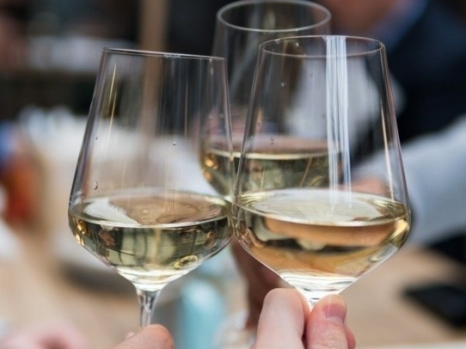 Three filled wine glasses with white wine in a convivial round. Background blurred., © Cool-Tours StattReisen Three filled wine glasses with white wine in a convivial round. Background blurred., © Cool-Tours StattReisen