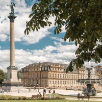 Stuttgart's Schlossplatz features the Jubilee Column and the New Palace. People are enjoying the sunny day, while trees line the square., &copy; SMG Stuttgart Marketing GmbH - Sarah Schmid