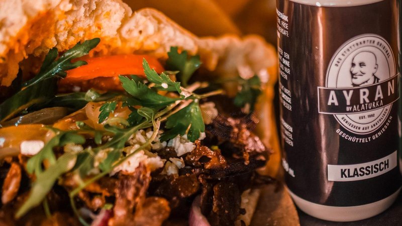 Nahaufnahme eines Döners mit Gemüse und zwei Ayran-Getränken von Alaturka, klassisch und Minze & Dill., © ALATURKA | Das Stuttgarter Original