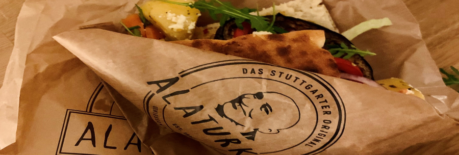 A sandwich with vegetables and cheese in an Alaturka paper bag labeled "The Stuttgart Original"., &copy; Stuttgart-Marketing GmbH