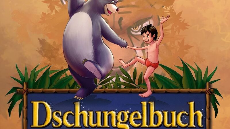 Balu der B&auml;r und Mogli tanzen fr&ouml;hlich vor einem Hintergrund mit Bl&auml;ttern und einem Tigerauge. Der Schriftzug 'Dschungelbuch &ndash; das Musical' ist prominent platziert., &copy; Theater Liberi
