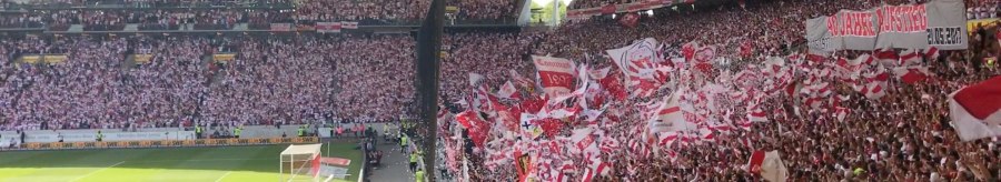 Blick in die Cannstatter Kurve der Mercedes-Benz Arena Stuttgart. Fans schwenken rot-wei&szlig;e Fahnen und halten Banner hoch. Die Trib&uuml;nen sind voll besetzt., &copy; Stuttgart-Marketing GmbH