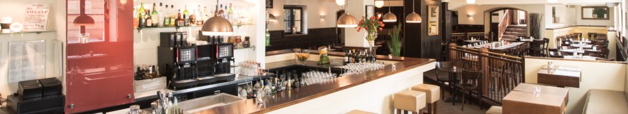 Stylish restaurant with bar, wooden furniture and laid tables. Bright lighting and cozy atmosphere., © Amadeus, Stuttgart