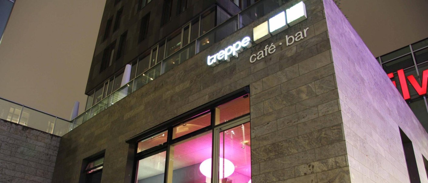 Modernes Gebäude mit der Aufschrift 'treppe café · bar' und beleuchteten Fenstern in der Nacht., © Café Treppe, Stuttgart