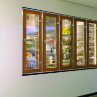 Entrance to "karls kitchen" with illuminated glass cabinets full of food and a view of the modern kitchen., &copy; karls kitchen, Stuttgart