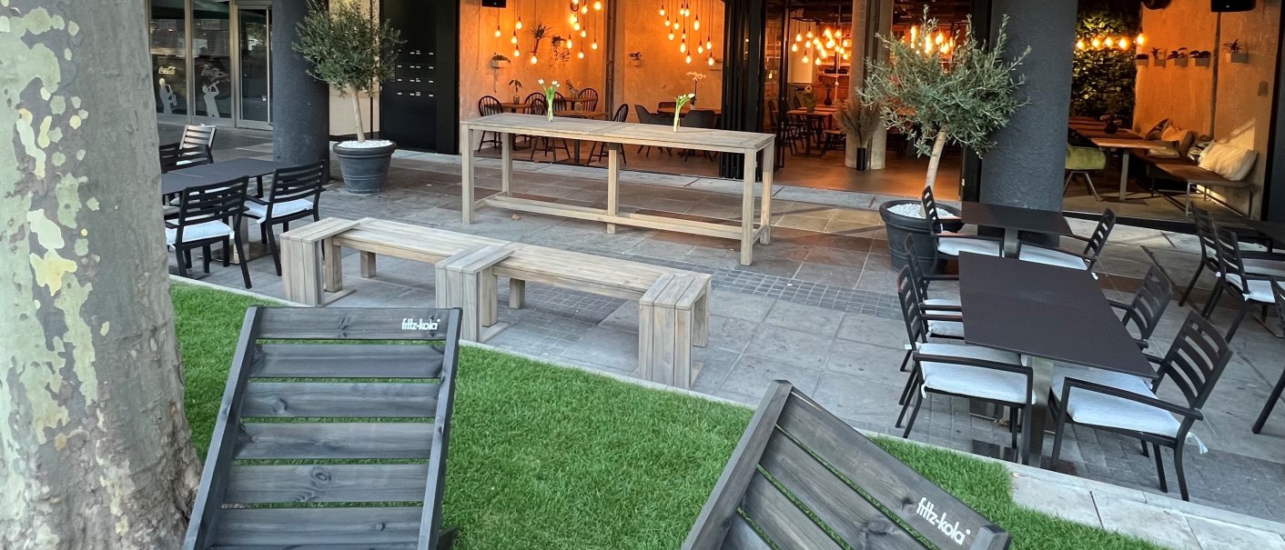 Cozy outdoor area with wooden furniture, lawn and fairy lights. Indoor area with warm light visible., &copy; heavenskitchen