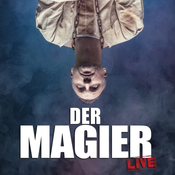 A man in a straitjacket hanging upside down in front of a foggy background. Text: 'The Magician Live' in large letters., © Theaterhaus Stuttgart e.V. A man in a straitjacket hanging upside down in front of a foggy background. Text: 'The Magician Live' in large letters., © Theaterhaus Stuttgart e.V.