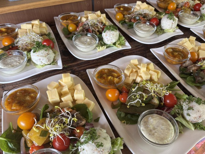 Plate of tapas: cheese cubes, tomatoes, sauces and salad arranged on a wooden table., &copy; Cool-Tours StattReisen