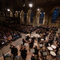 An orchestra and choir perform in a church in front of a large audience. The church has high windows and an organ., © www.hassfoto.de An orchestra and choir perform in a church in front of a large audience. The church has high windows and an organ., © www.hassfoto.de