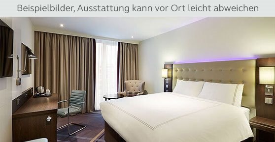 A modern hotel room with a large bed, a desk, a chair, and an armchair. Subtle lighting and light-colored curtains., © Premier Inn A modern hotel room with a large bed, a desk, a chair, and an armchair. Subtle lighting and light-colored curtains., © Premier Inn
