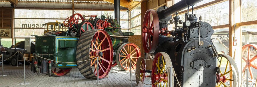 Historic tractors and machines in the German Agricultural Museum, exhibited in a hall with large windows., © Stuttgart Marketing GmbH, Sarah Schmid