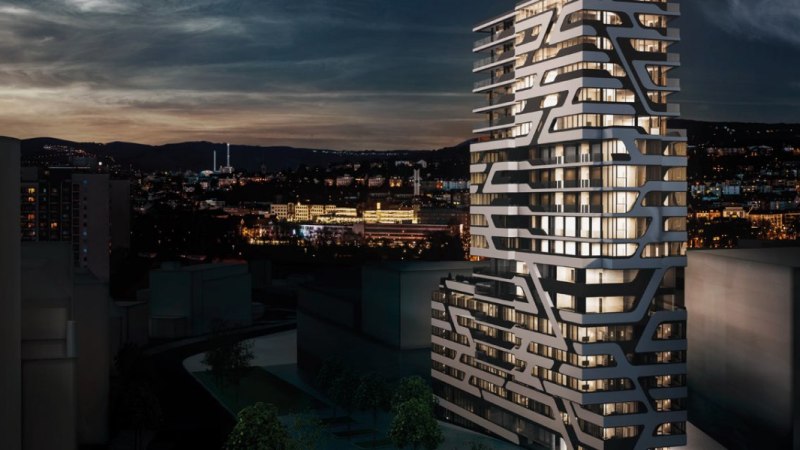 Ein modernes Hochhaus mit einzigartigem Design bei Nacht, beleuchtet, mit einer Stadtlandschaft im Hintergrund., &copy; Jaz Hotel Stuttgart