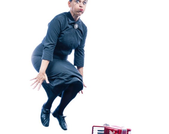Woman in a dark dress jumps next to a red accordion on a white background., &copy; Rosenau Kultur e.V.