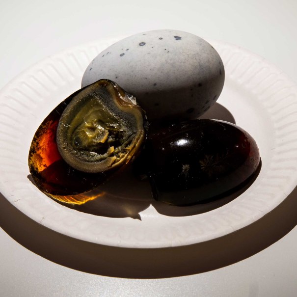 Ein Teller mit einem grauen Ei und einem aufgeschnittenen, dunklen Ei mit grünlichem Inneren., © Foto: Anja Barte Telin Ein Teller mit einem grauen Ei und einem aufgeschnittenen, dunklen Ei mit grünlichem Inneren., © Foto: Anja Barte Telin