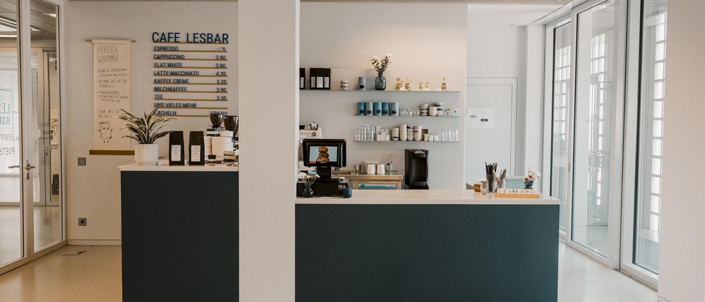 Modern café with counter, price board and shelves in the Stuttgart City Library. Bright, inviting atmosphere on the 8th floor., © sina fotografie, Café Lesbar, Stuttgart Modern café with counter, price board and shelves in the Stuttgart City Library. Bright, inviting atmosphere on the 8th floor., © sina fotografie, Café Lesbar, Stuttgart