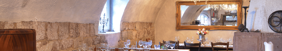 Cozy dining room with covered wooden tables, chandelier, mirror and rustic stone walls. Elegant atmosphere with candles and flowers., &copy; FreCla Gastronomiebetriebe GmbH