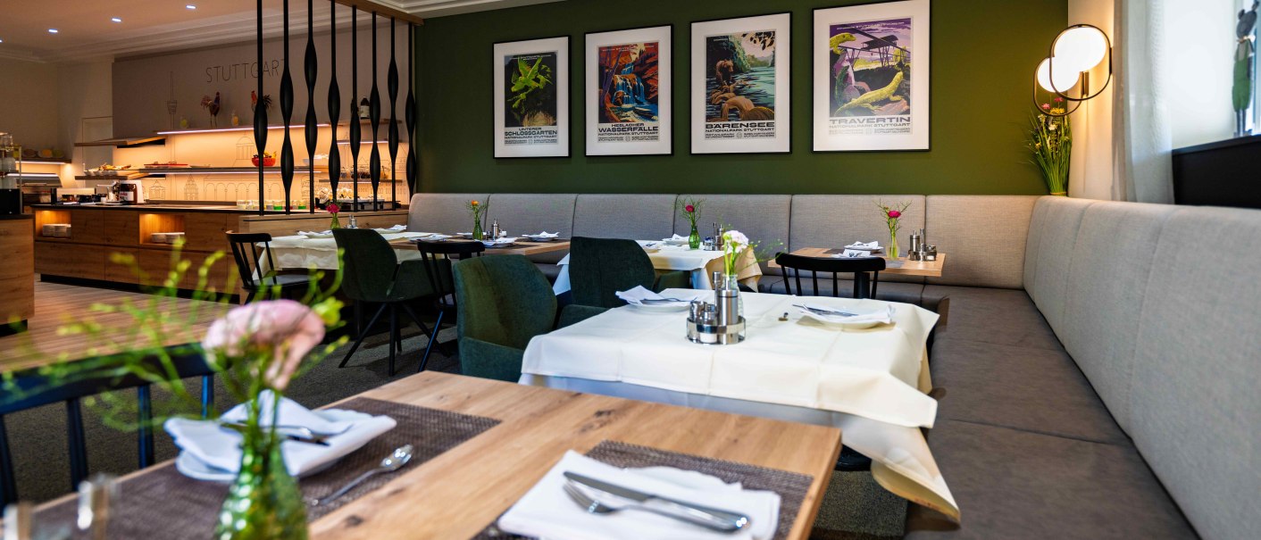 Modern restaurant with stylish furnishings, decorative posters and laid tables. The atmosphere is inviting and elegant., &copy; TOMAS