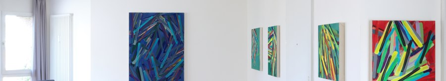 Gallery with abstract paintings on white walls, wooden floor, armchair and purple flowers in a vase., &copy; Galerie Klaus Braun