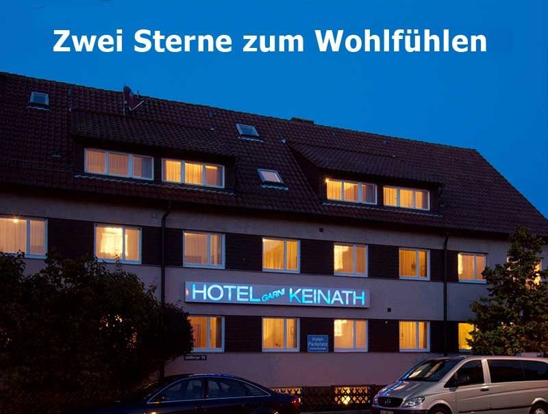 Hotel Keinath at night, illuminated windows, lettering "Zwei Sterne zum Wohlf&uuml;hlen" above, cars in the foreground., &copy; Hotel Keinath