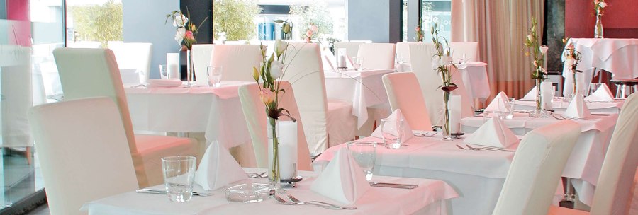 Elegant restaurant with white tablecloths, stylishly laid tables and flower arrangements. Bright, modern furnishings with large windows., &copy; &Acirc;&copy; AMICI