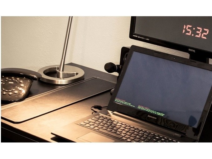 Desk with laptop, table lamp, old telephone and monitor showing 15:32., © ExitGames Stuttgart Desk with laptop, table lamp, old telephone and monitor showing 15:32., © ExitGames Stuttgart