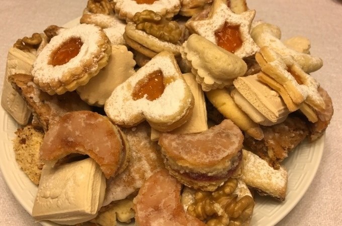 Ein Teller voller bunter Weihnachtsplätzchen, darunter Kekse mit Marmelade, Nüssen und Puderzucker., © Weingenuss Stuttgart