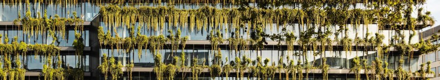 A modern building with a lush green fa&ccedil;ade and large glass windows. Plants hang down from the floors., &copy; SMG Stuttgart Marketing GmbH - Sarah Schmid