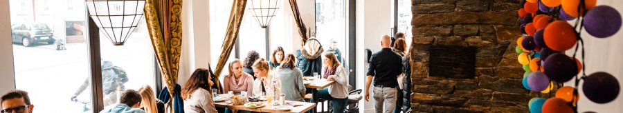 Cosy café with large windows, people at tables, colorful baubles on the wall and a fireplace. Warm, inviting atmosphere., © SMG, Sarah Schmid