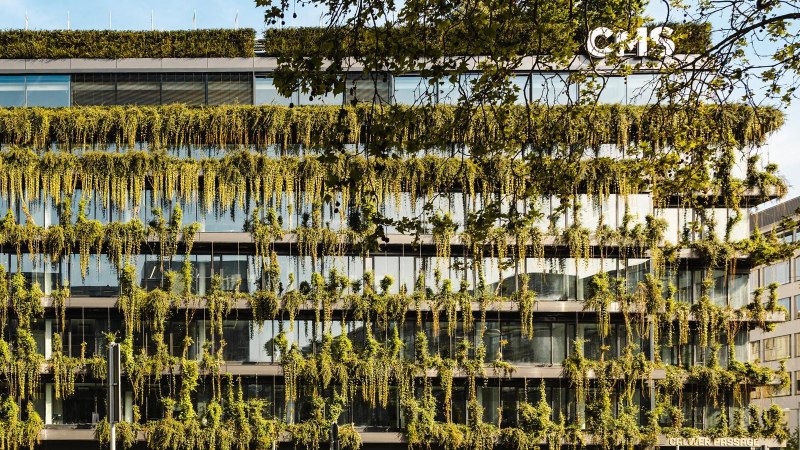 A modern building with a lush green fa&ccedil;ade and large glass windows. Plants hang down from the floors., &copy; SMG Stuttgart Marketing GmbH - Sarah Schmid