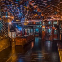 Club with vinyl records on the walls and ceiling, disco balls and bar. Atmospheric lighting and empty dance floor., &copy; Goldmarks, Stuttgart