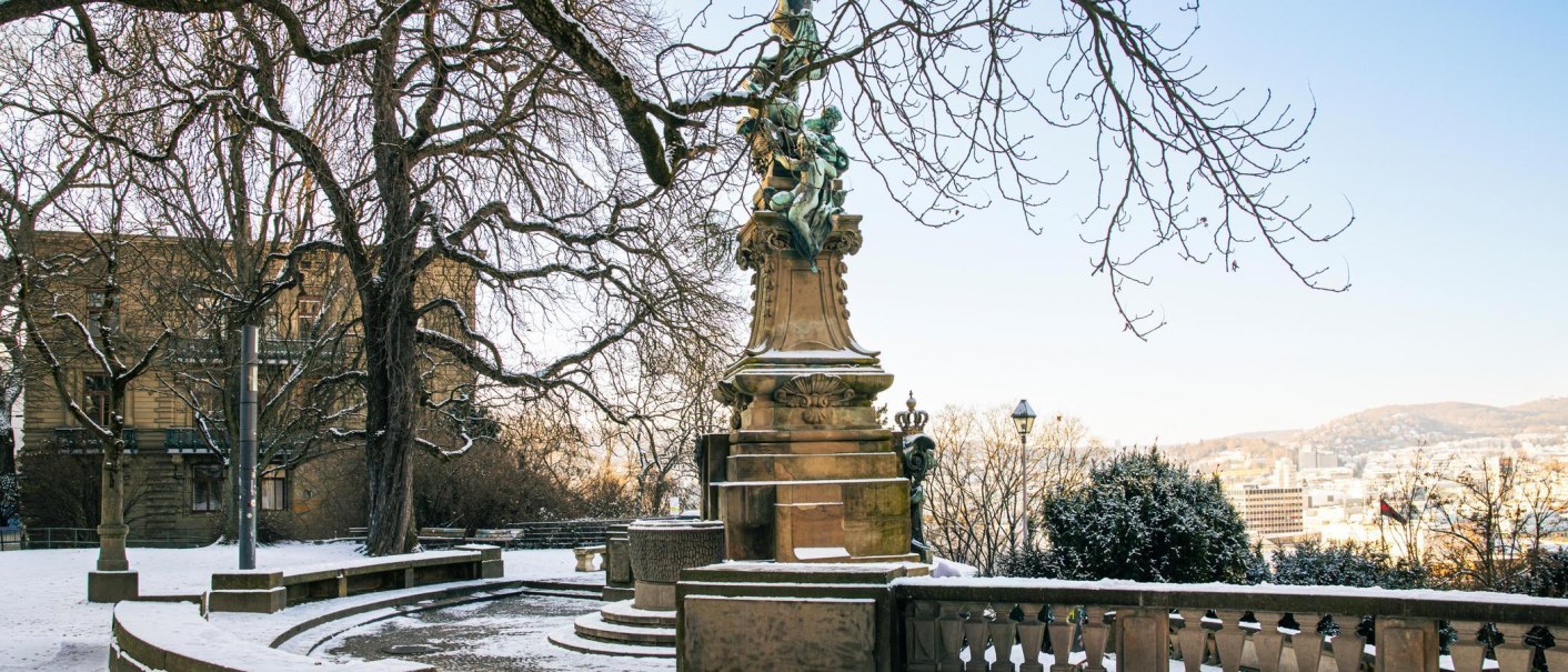 Snow-covered Eugensplatz in Stuttgart with the Galatea Fountain in the foreground. The trees are bare and the city is visible in the background., &copy; Stuttgart-Marketing GmbH, Sarah Schmid