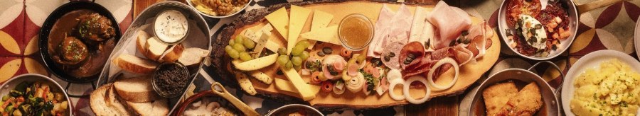 A table full of traditional German dishes, including cheese, sausage, bread, lentils, potatoes and various side dishes., &copy; &copy; Gasthaus B&auml;ren Stuttgart
