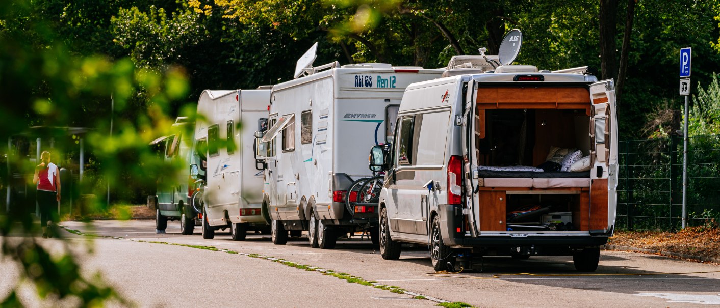 Mehrere Wohnmobile parken auf einem Stellplatz, umgeben von Bäumen. Eine Person geht in der Nähe vorbei., © Stuttgart-Marketing GmbH, Thomas Niedermüller Mehrere Wohnmobile parken auf einem Stellplatz, umgeben von Bäumen. Eine Person geht in der Nähe vorbei., © Stuttgart-Marketing GmbH, Thomas Niedermüller