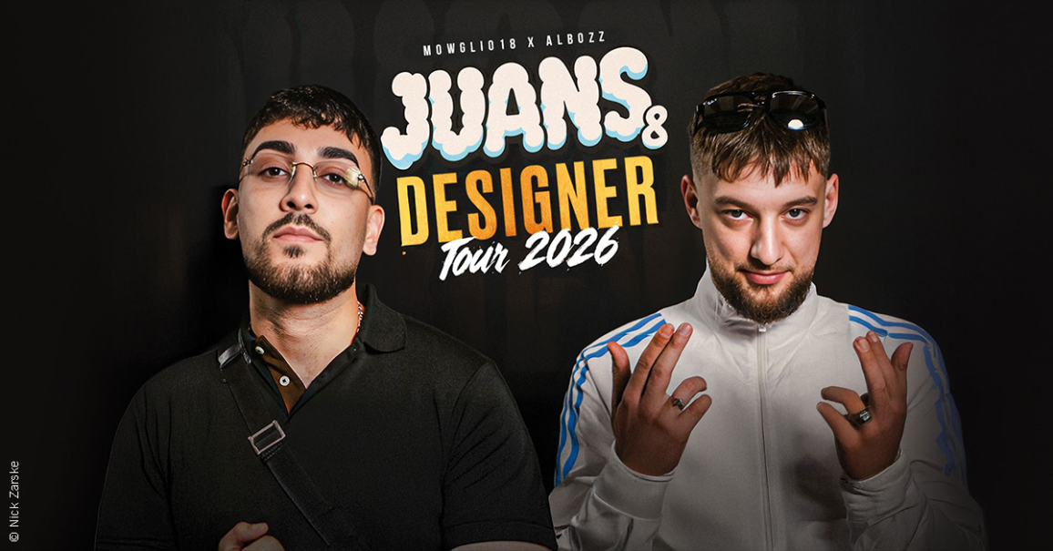 Zwei M&auml;nner posieren vor einem Poster f&uuml;r die 'Juans & Designer Tour 2026'. Einer tr&auml;gt eine Brille, der andere eine wei&szlig;e Jacke., &copy; links im Bild