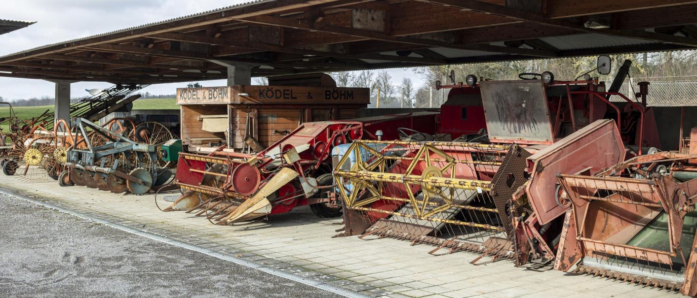 Historical agricultural machinery and equipment under a covered outdoor area, exhibited in the German Agricultural Museum., © Stuttgart Marketing GmbH, Sarah Schmid