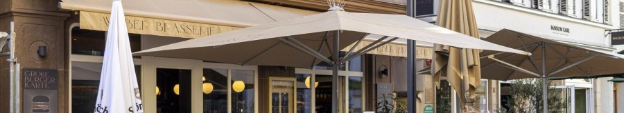 A caf&eacute; called 'Weber' has an outdoor area with tables, chairs and parasols. People sit and enjoy drinks., &copy; SMG, Sarah Schmid