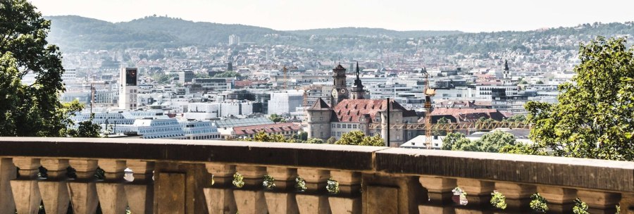 View of Stuttgart from Eugensplatz, with historic buildings and green hills in the background. A railing in the foreground., &copy; Stuttgart-Marketing GmbH Romeo Felsenreich, sommertage.com